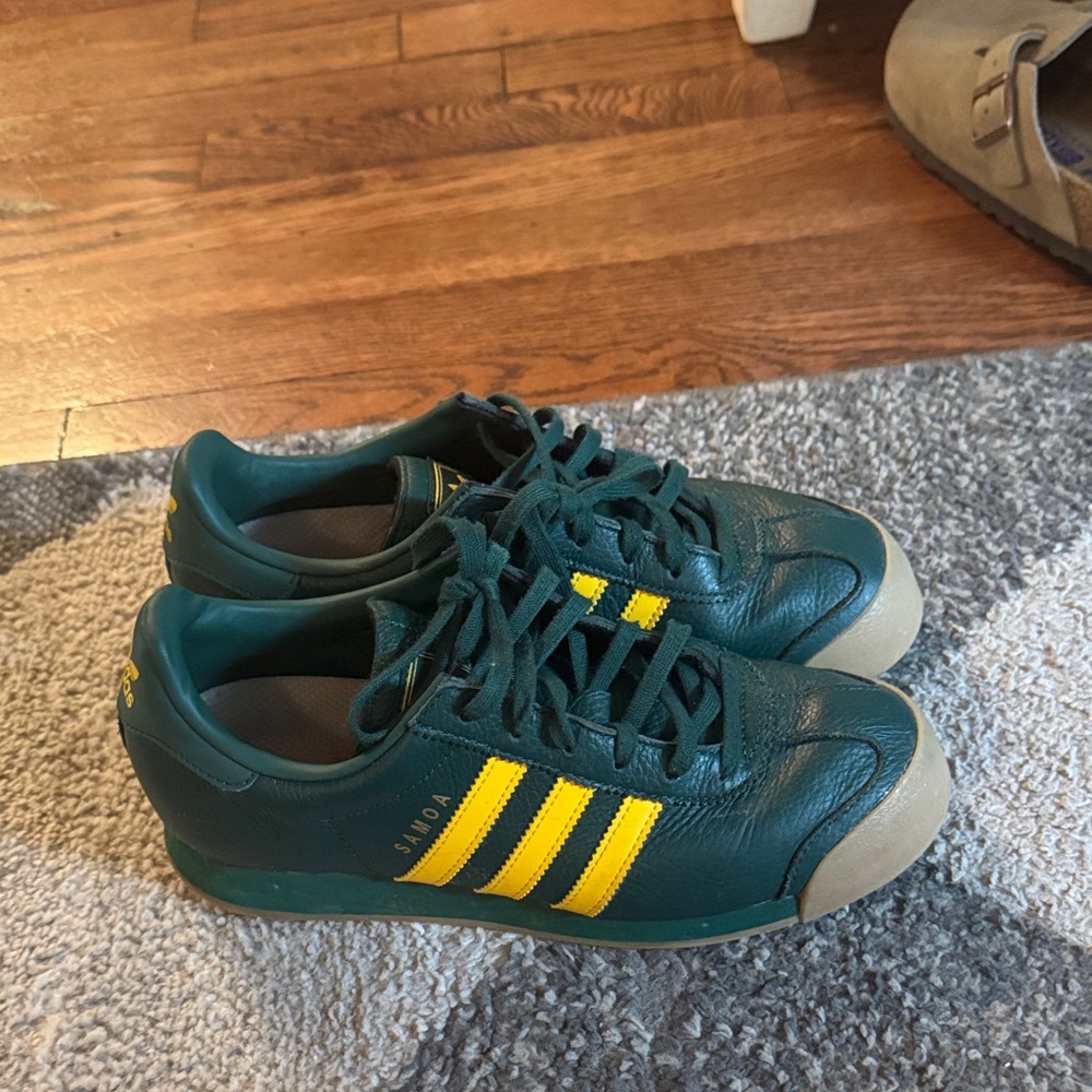 Adidas Samoa Dark Green Sneakers with Bright Yellow Stripes.
